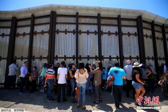资料图：美墨边境临时短暂开放，在美国加州圣迭戈一侧的人们排队等待与亲人见面。
